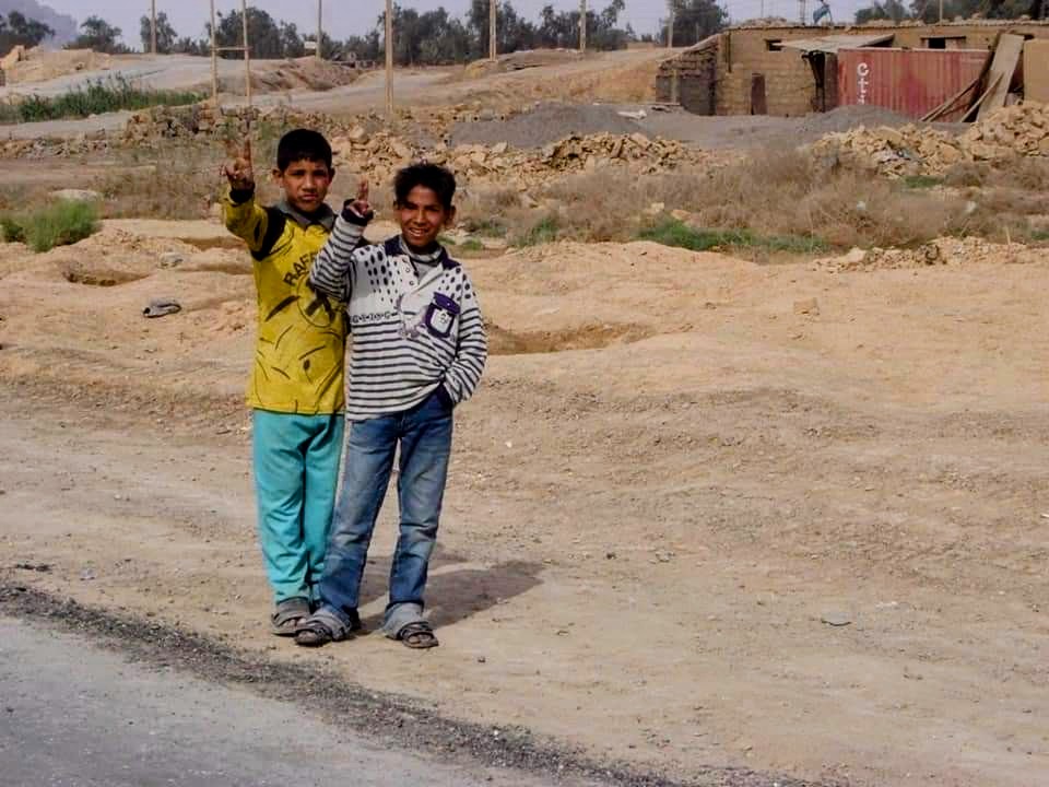 Children in Iraq giving us Marines the peace sign