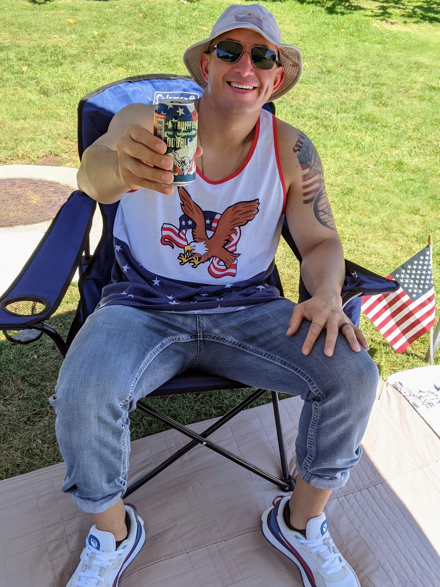 Marine Miguel drinking a beer celebrating the 4th of July at the park wearing red, white & blue